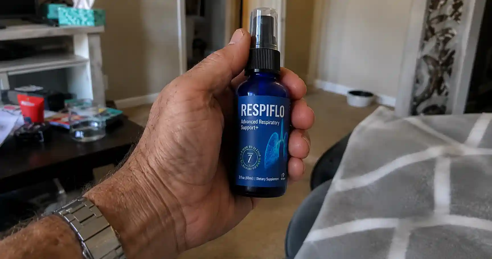 man holding respi flo supplement bottle