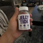 Hand holding Jelly Tide gummies bottle