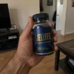 Hand holding JellyFil Supplement bottle