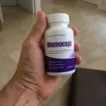 Hand holding Memocept supplement bottle