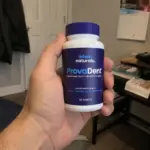 Hand holding ProvaDent oral probiotic bottle