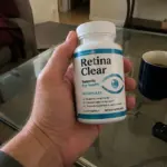 Hand holding Retina Clear supplement bottle