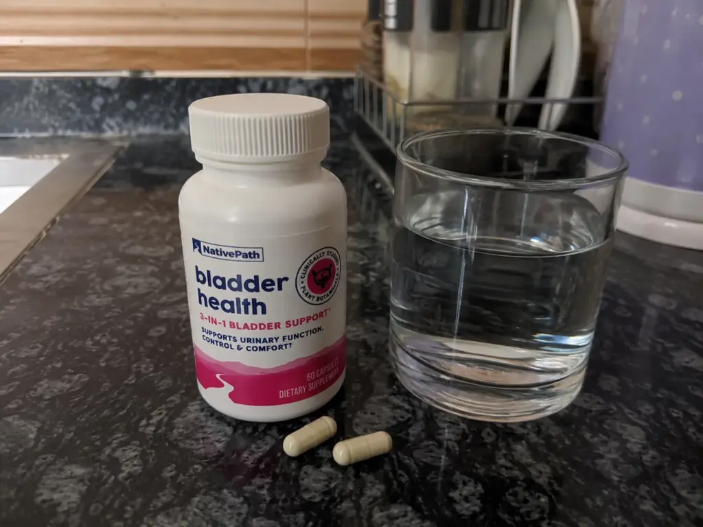 Supplement bottle and water on counter