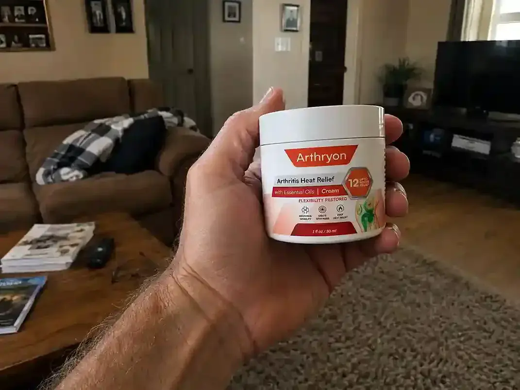 hand holding Arthryon Cream Bottle