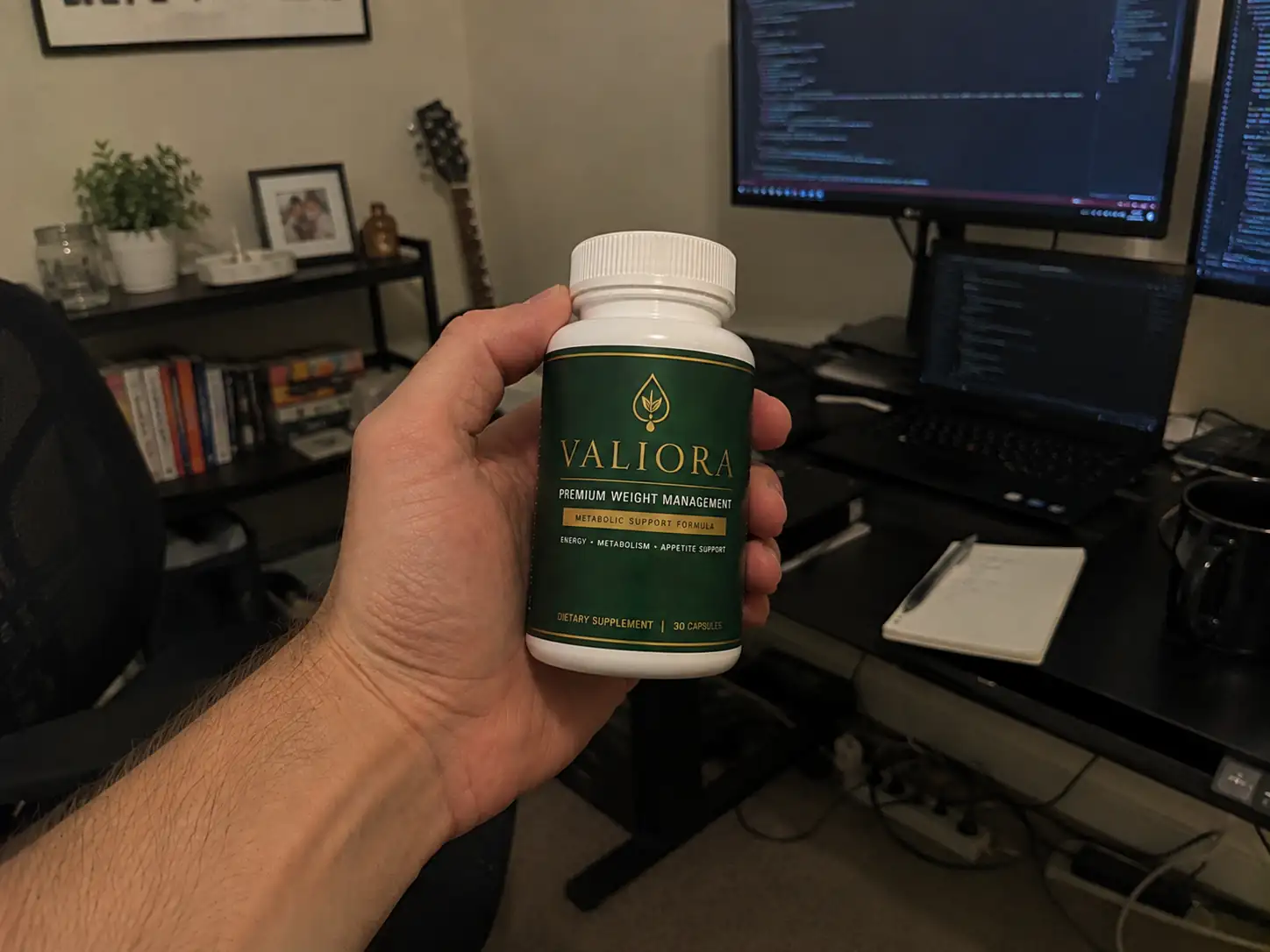 hand holding Valiora supplement boottle