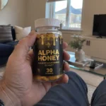 hand holding Alpha Honey gummies bottle