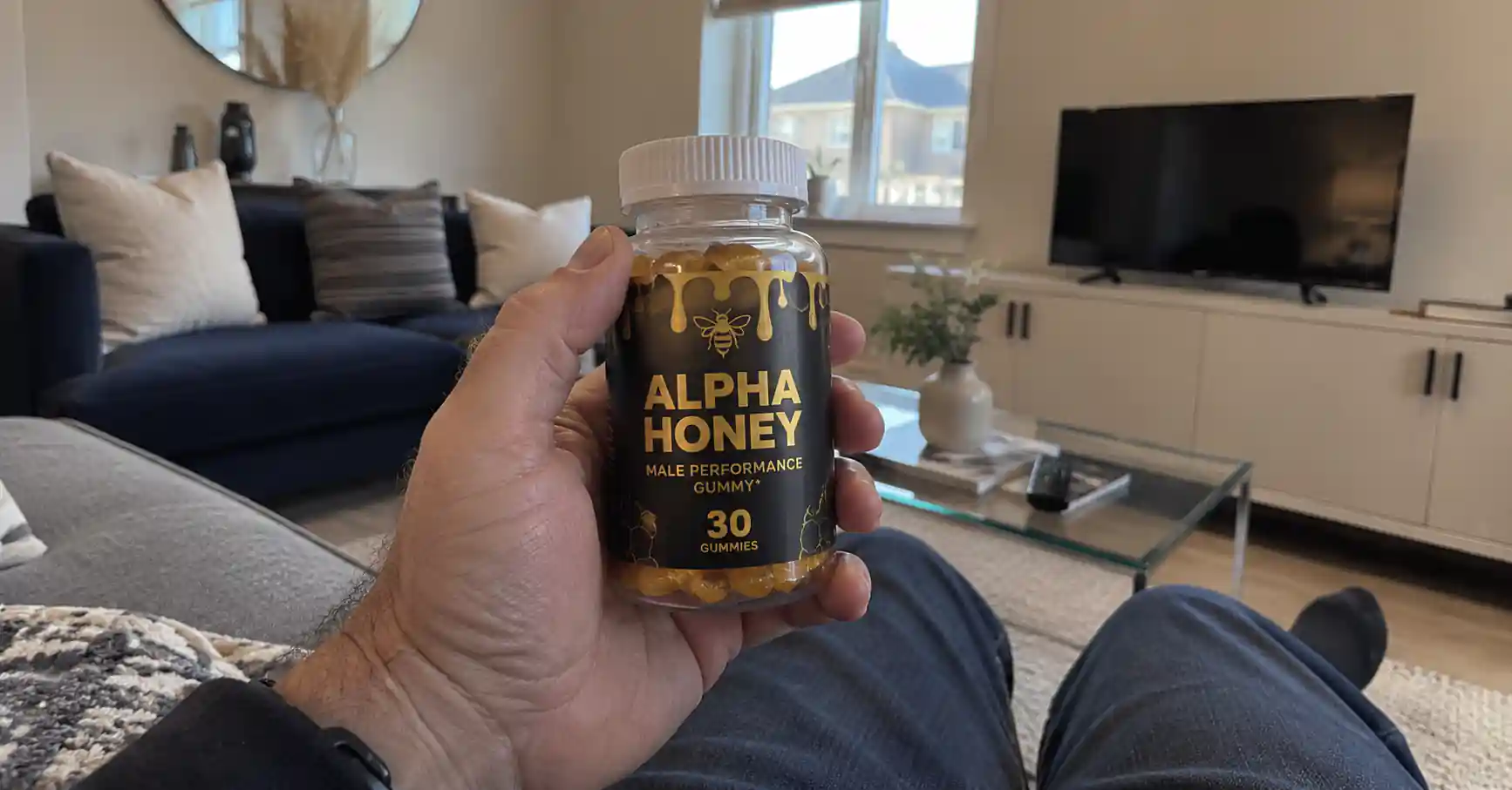 hand holding Alpha Honey gummies bottle