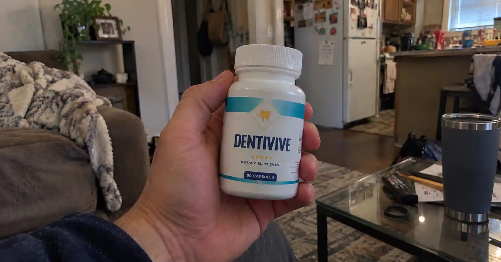 hand holding dentivive supplement bottle