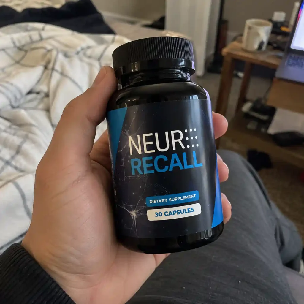 Hand Holding Neur Recall Supplement Bottle