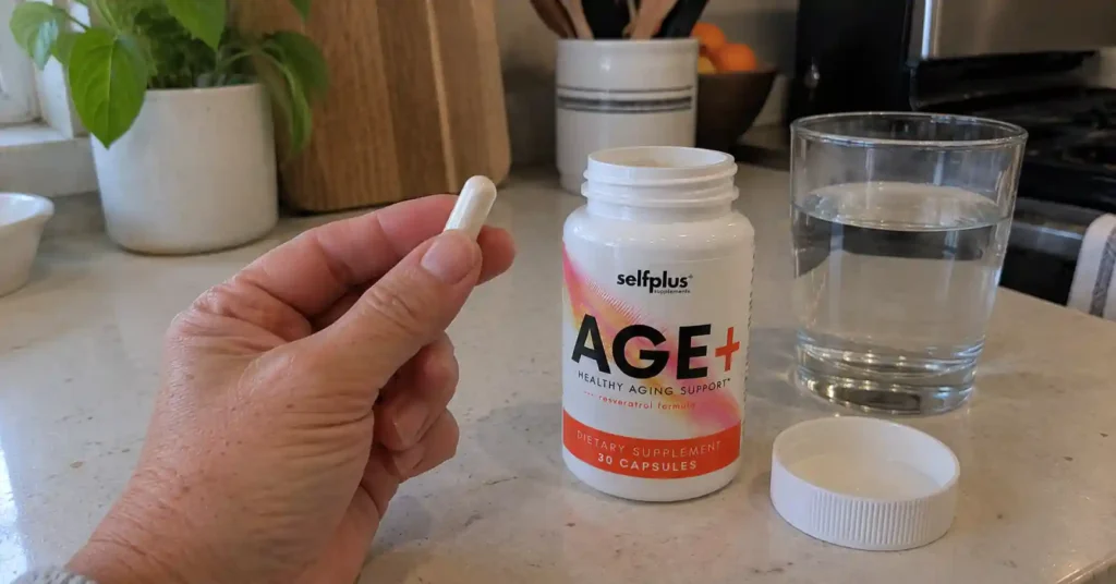 hand holding AGE+ capsules